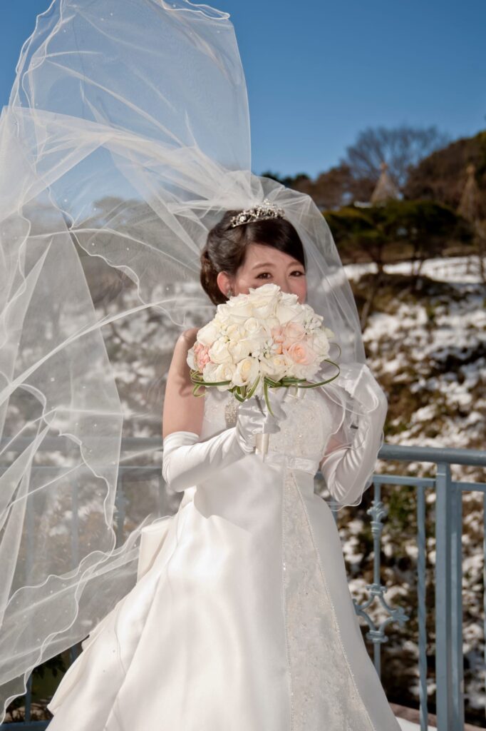 A woman in a wedding dress holding a bouquet of flowers